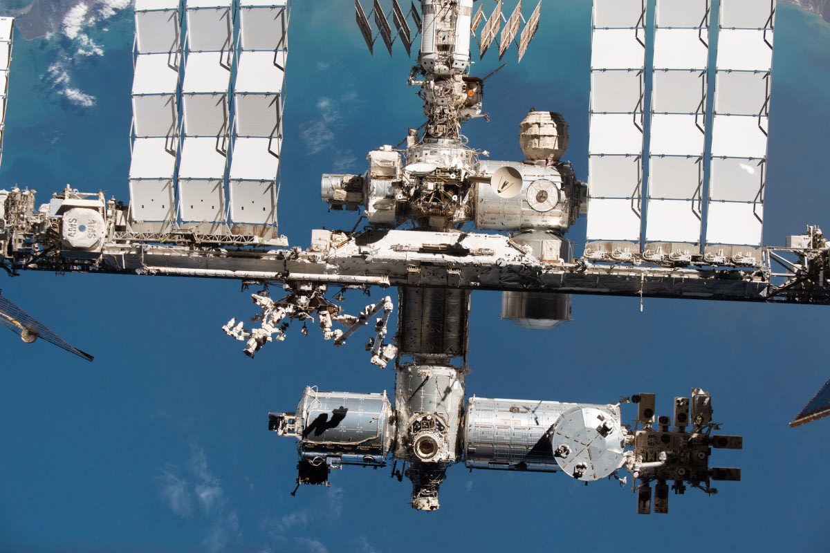 SpaceX Dragon spacecraft docked to the International Space Station orbiting Earth