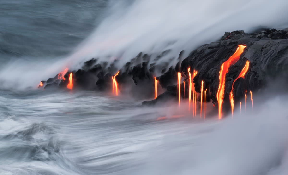 Underwater volcanic ridge releasing heat where tectonic plates meet ocean floor generating renewable energy