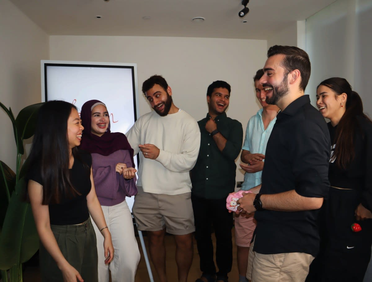 Six young entrepreneurs standing together inside London's Lift House founder residence smiling at camera