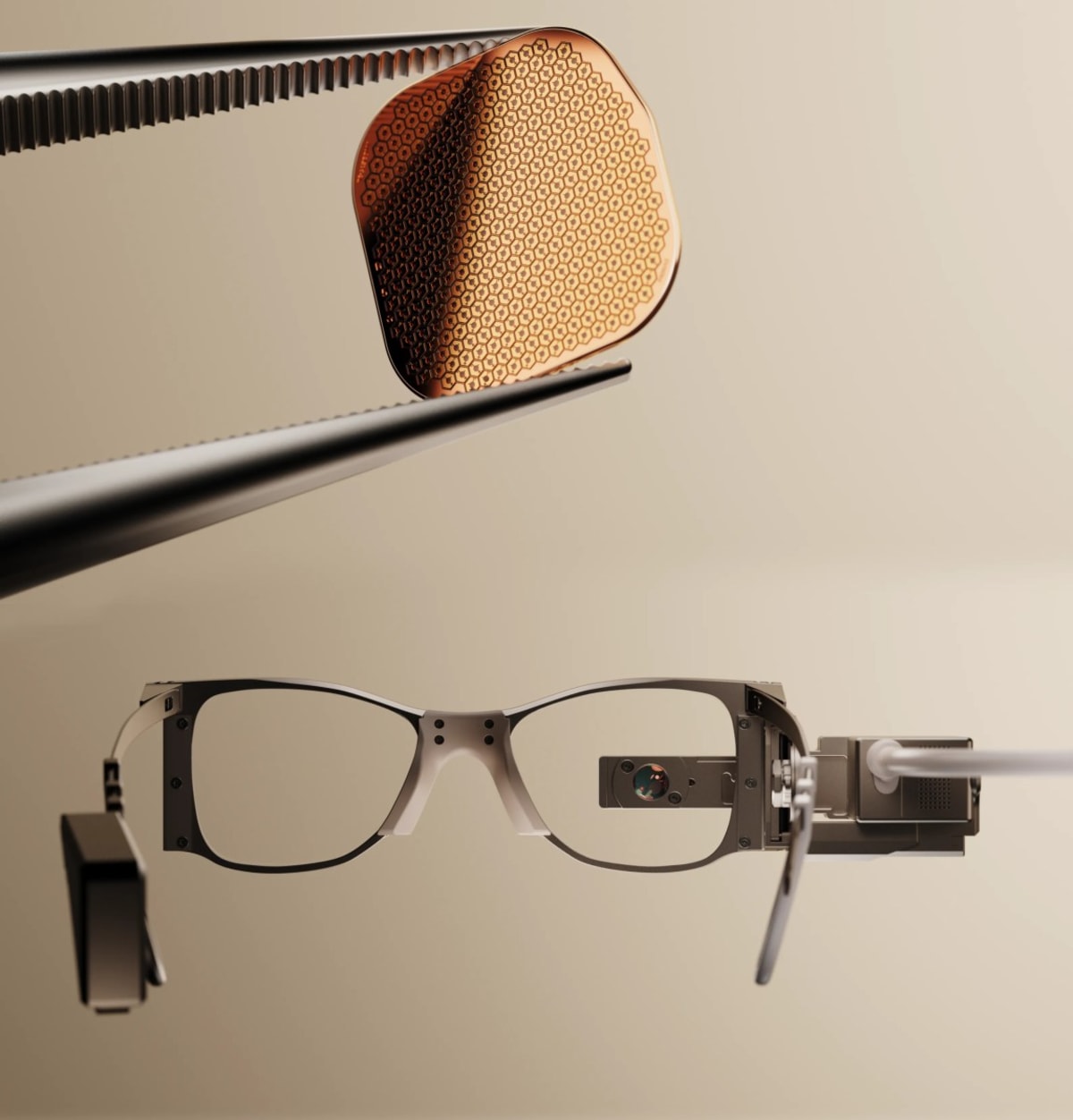 Close-up of tiny PRIMA vision chip next to camera-equipped glasses used to restore sight