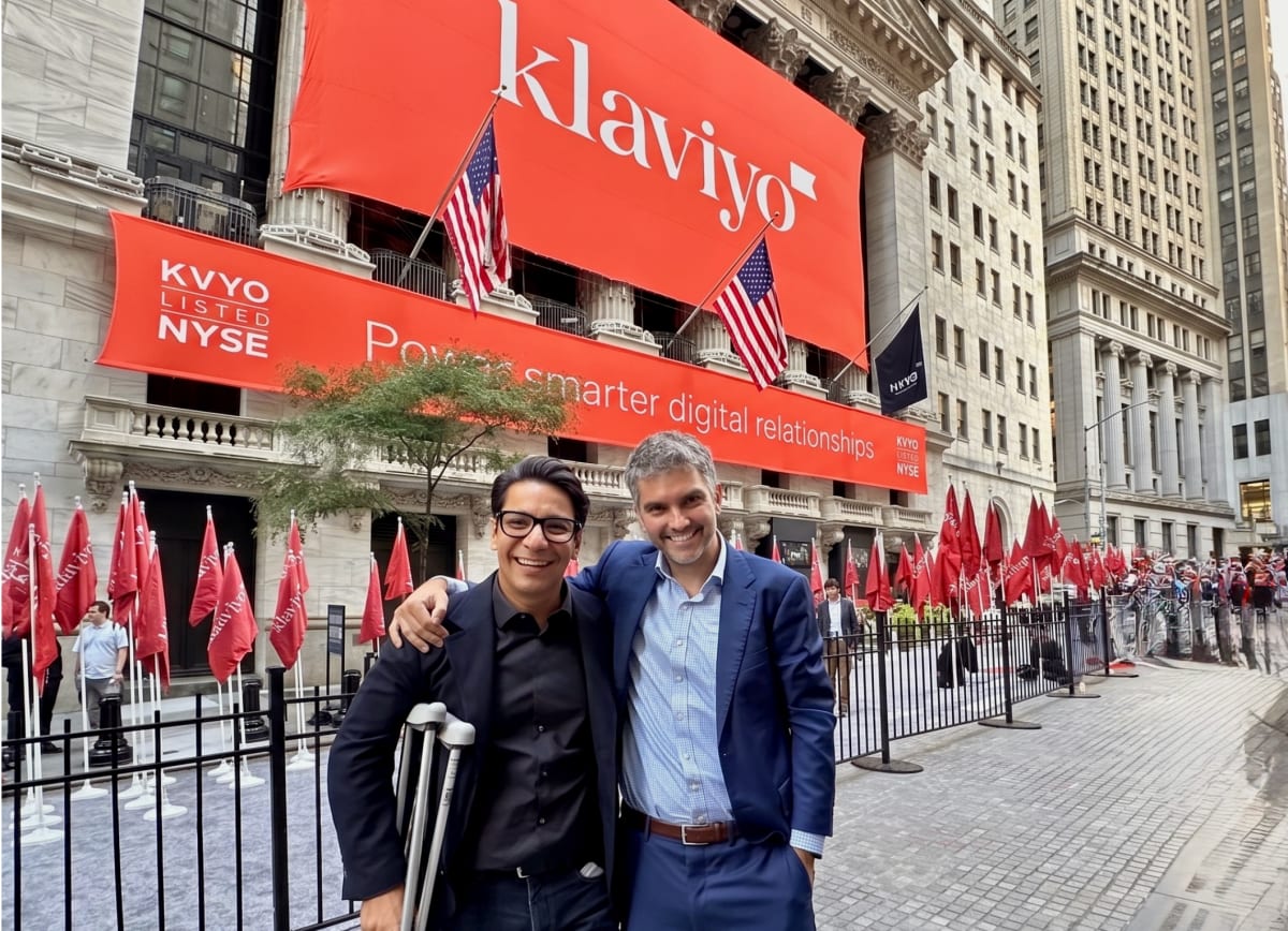Two tech entrepreneurs smiling together celebrating their business reunion after 15 years