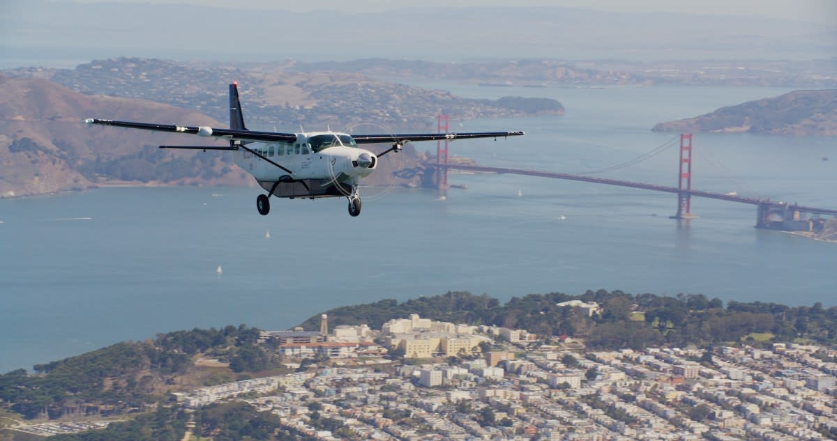 Autonomous Cessna Caravan aircraft flying over American landscape during historic cross-country journey