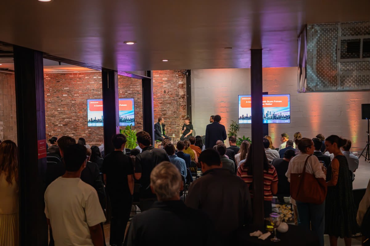 People gathered around an interactive touchscreen table playing games together in person