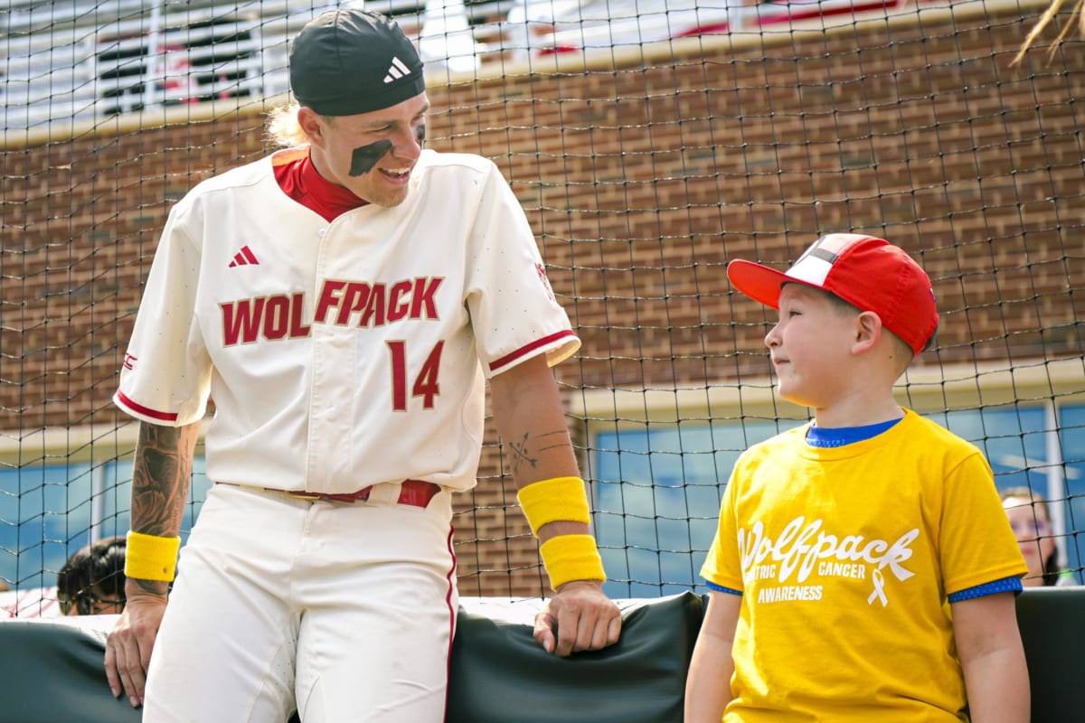 ** NC State baseball player Ty Head talking with Mathis Johnson before Victory Over Cancer game