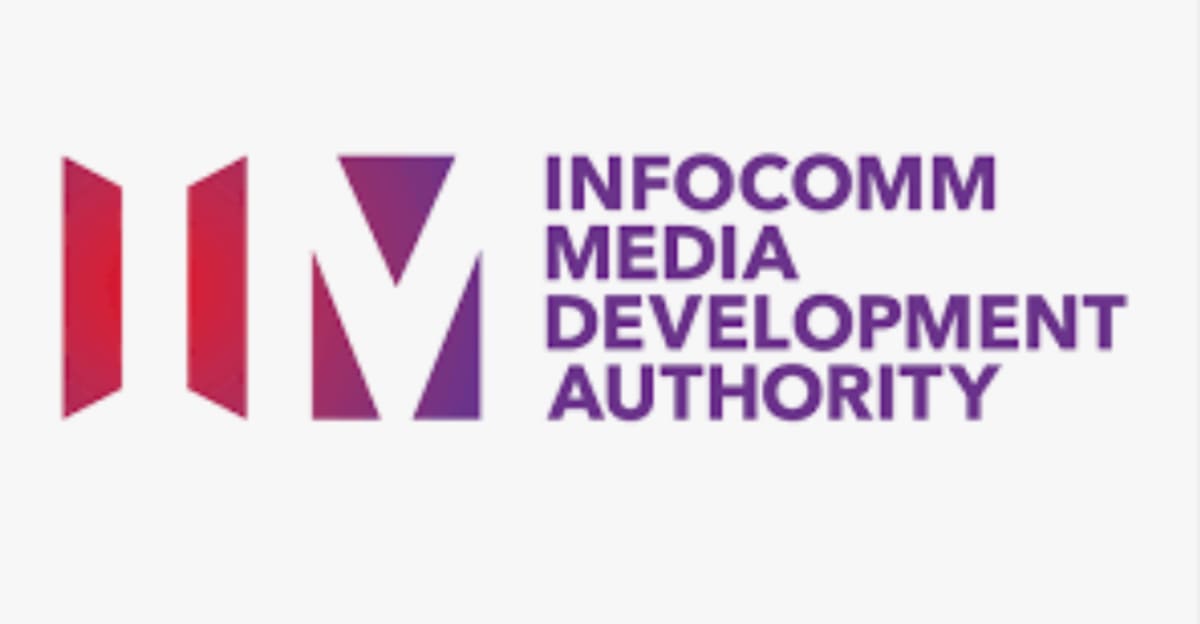 Young graduates working together on computers in modern Singapore tech training facility