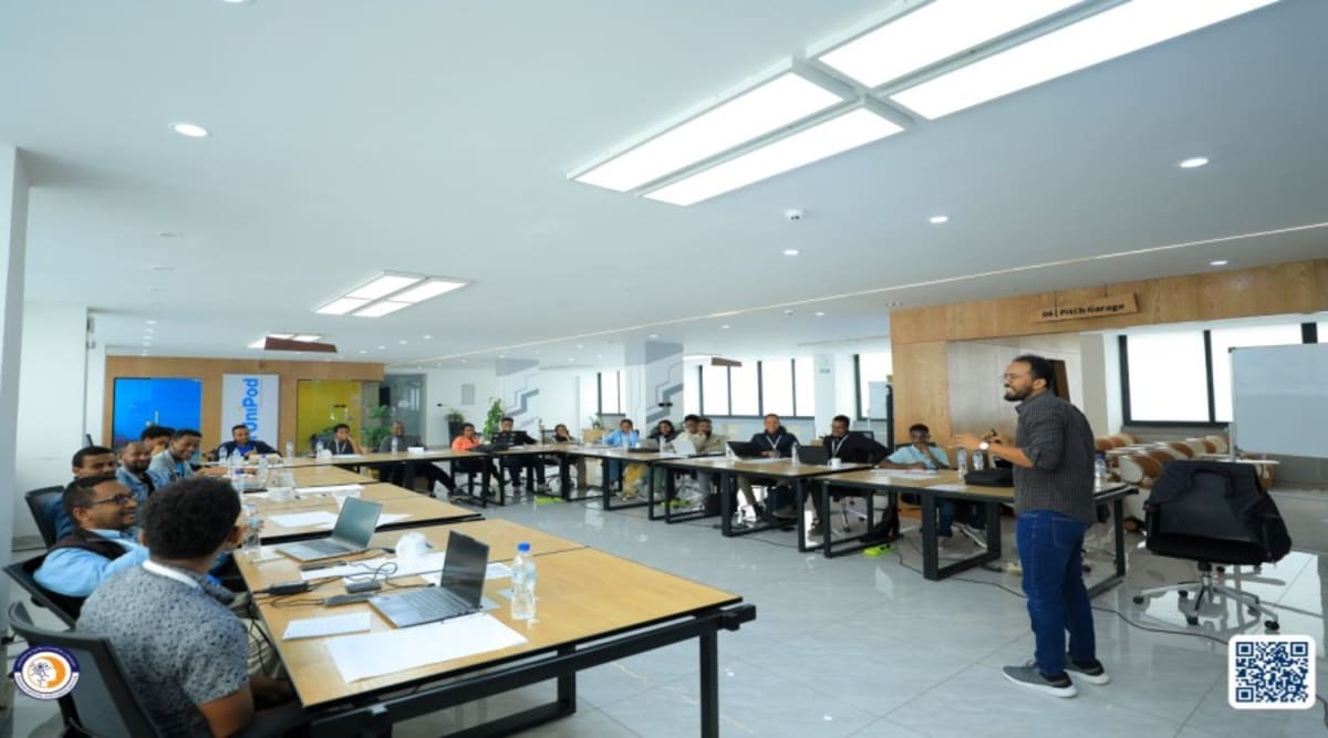 Ethiopian AI startup founders collaborating on laptops during intensive technology bootcamp training session