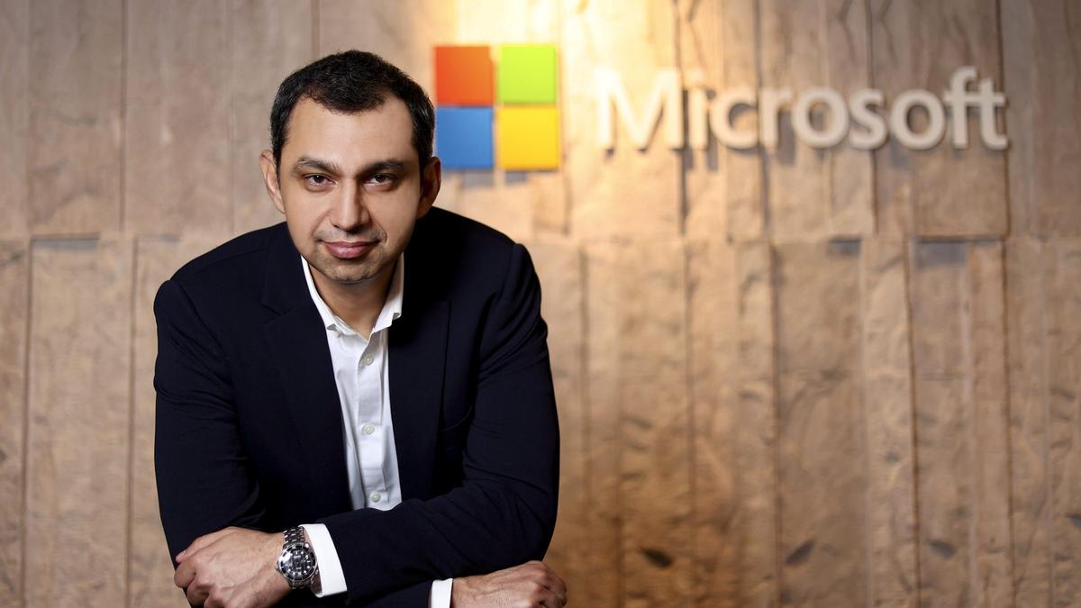 Indian professionals collaborating with AI technology in modern office workspace