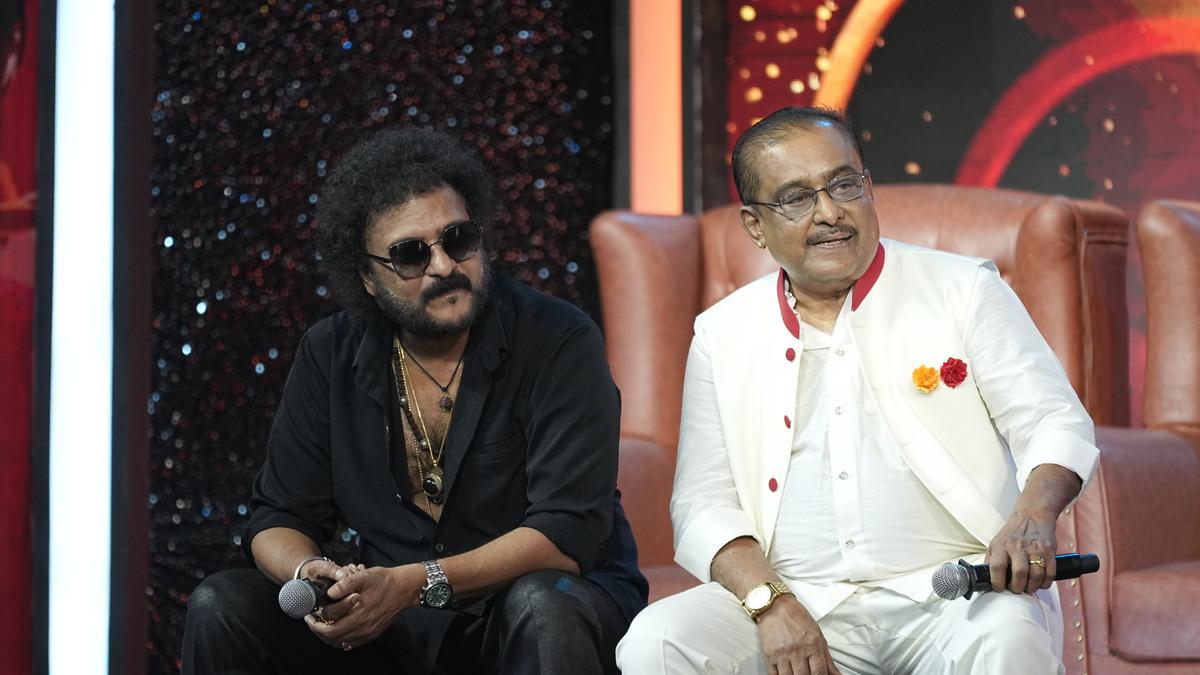 Music composer Hamsalekha and actor V Ravichandran embrace on stage during reunion concert