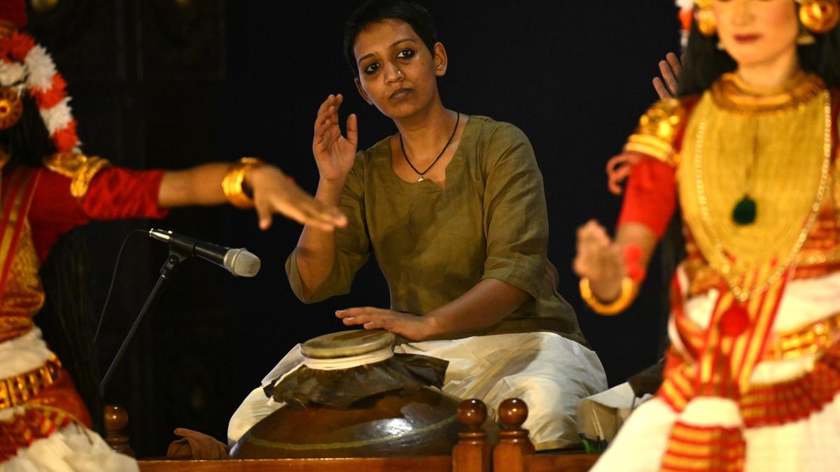 Apurva Arthur performing on traditional copper mizhavu drum at Kerala Kalamandalam graduation ceremony