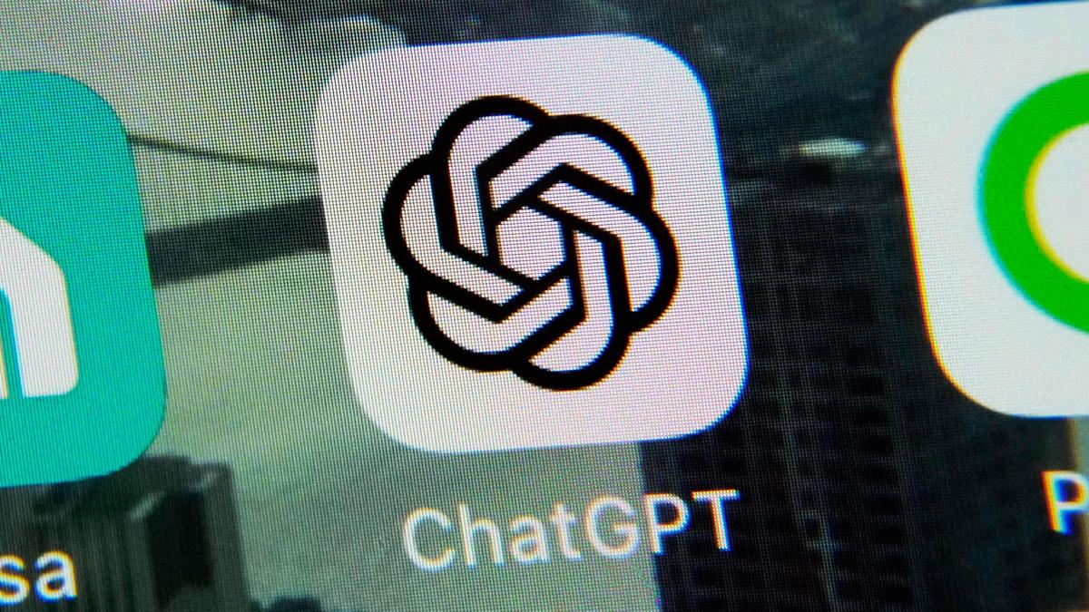 Teen using smartphone with parent nearby showing healthy technology oversight and family connection