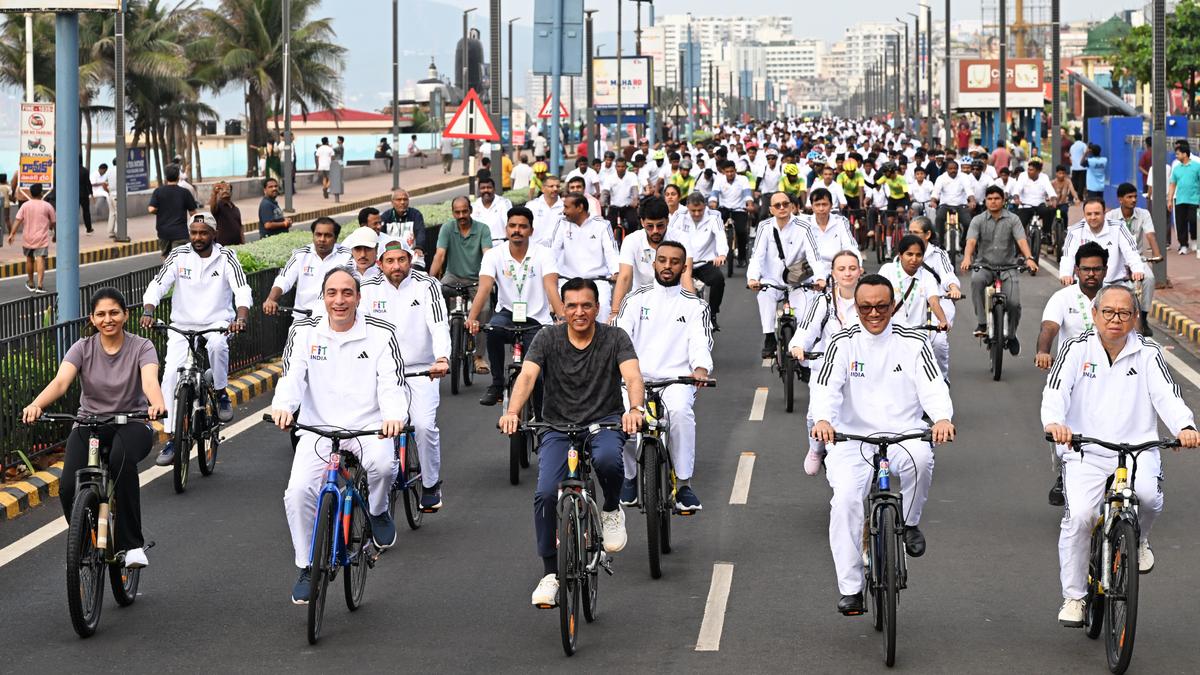 Large group of young cyclists riding together on city streets during India's Sunday cycling initiative