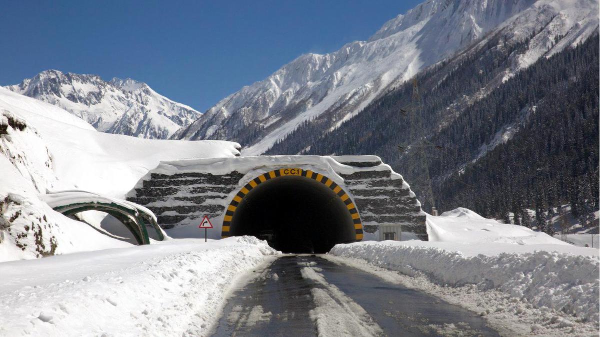 Aerial view of Zojila Tunnel entrance carved into snowy Himalayan mountainside in northern India