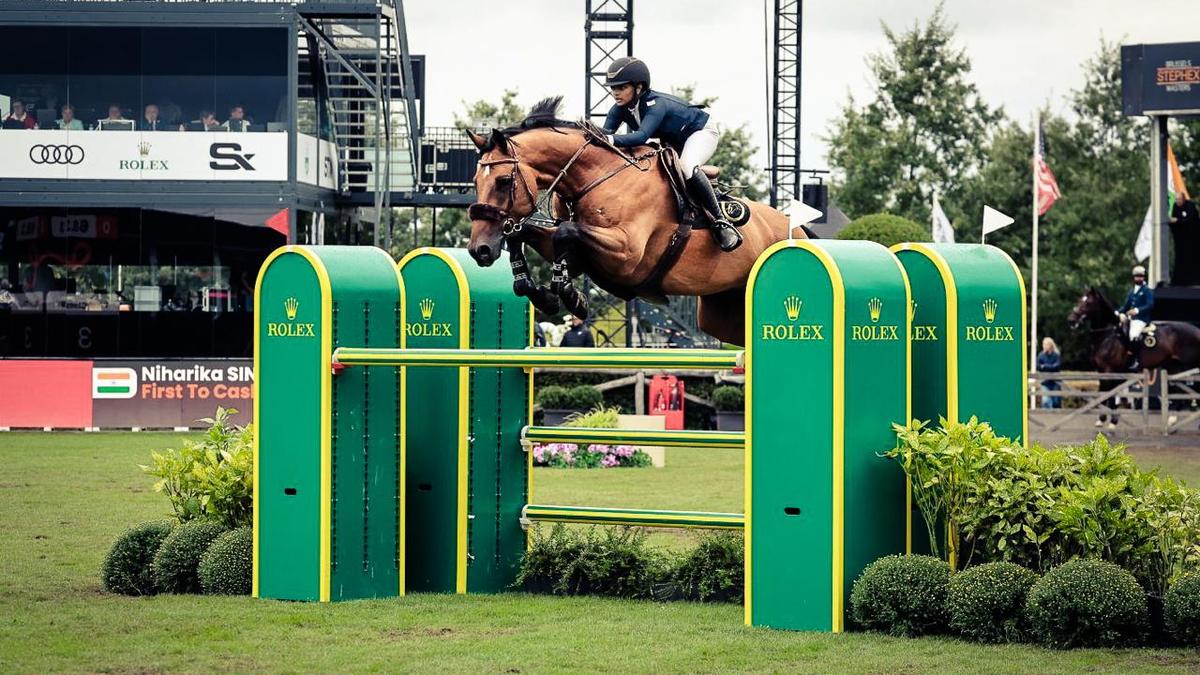 Young Indian equestrian Niharika Singhania jumping obstacle on horse at Brussels competition