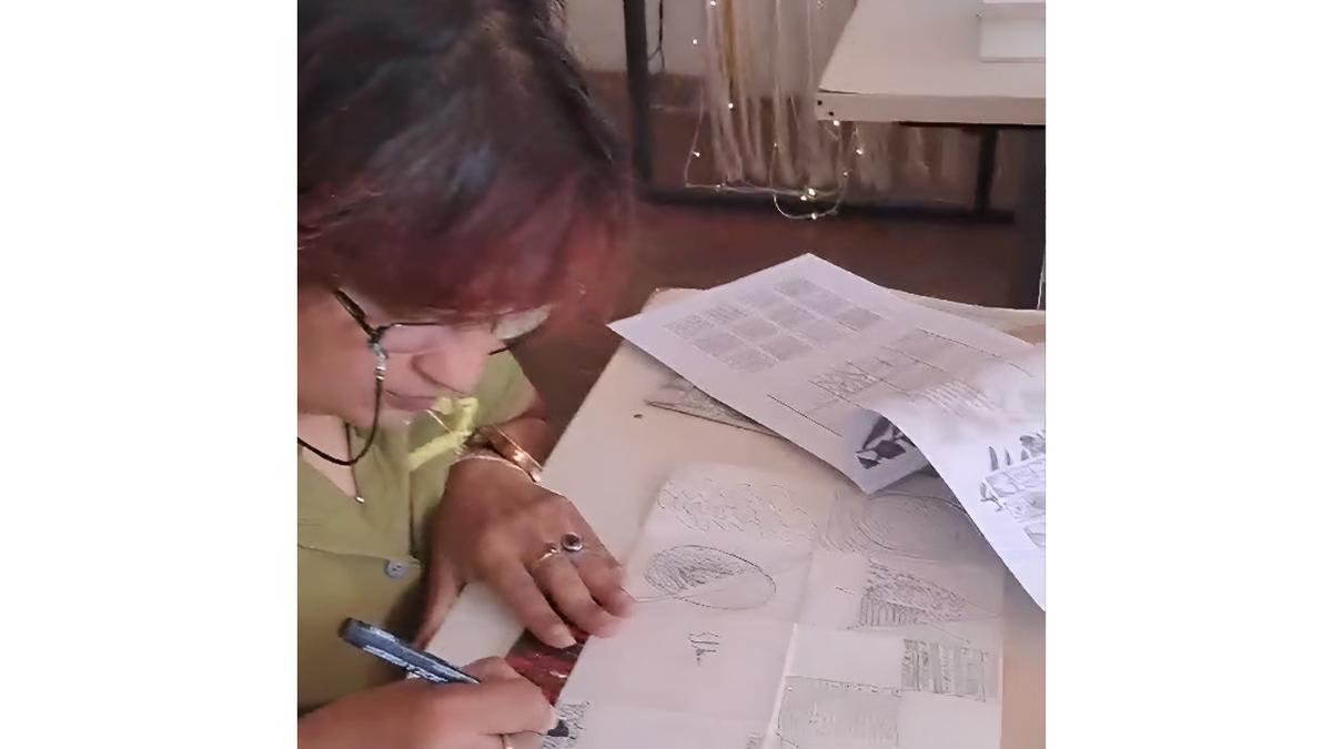 Adult hands working on colorful paper craft project at mindful decoupage workshop table