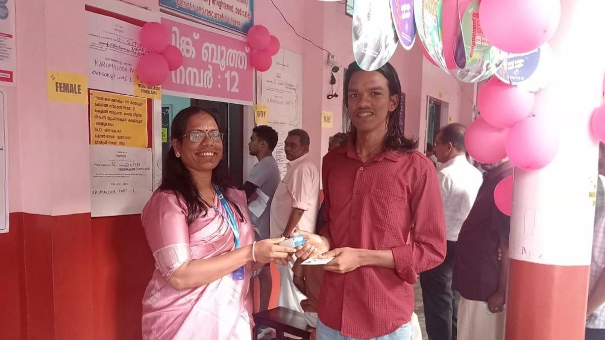 Young Indian voters at polling station receiving traditional halwa sweets from election officials