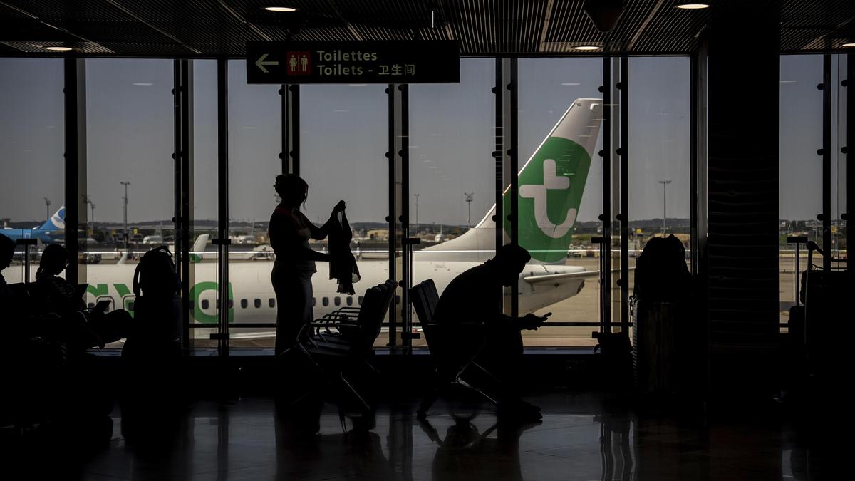 Modern airport terminal with international passengers walking through bright departure gates