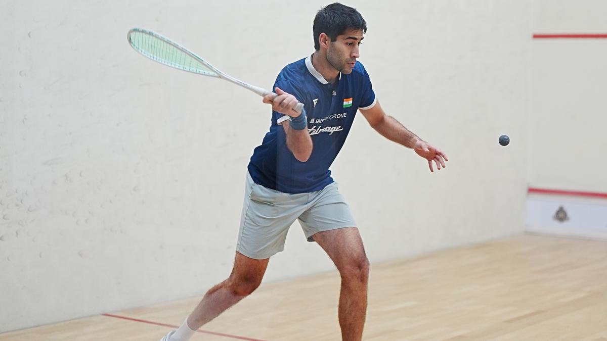 Squash player Ramit Tandon holding racket on court in athletic stance during training