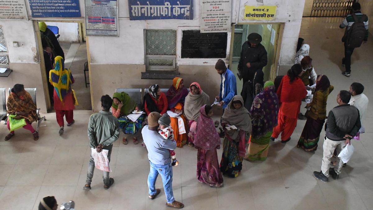 Healthcare worker using smartphone app to transmit patient emergency data in rural Indian clinic