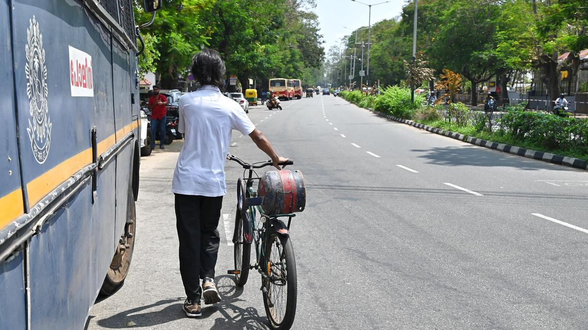 Migrant worker in India carrying affordable 5-kg LPG cylinder for cooking fuel