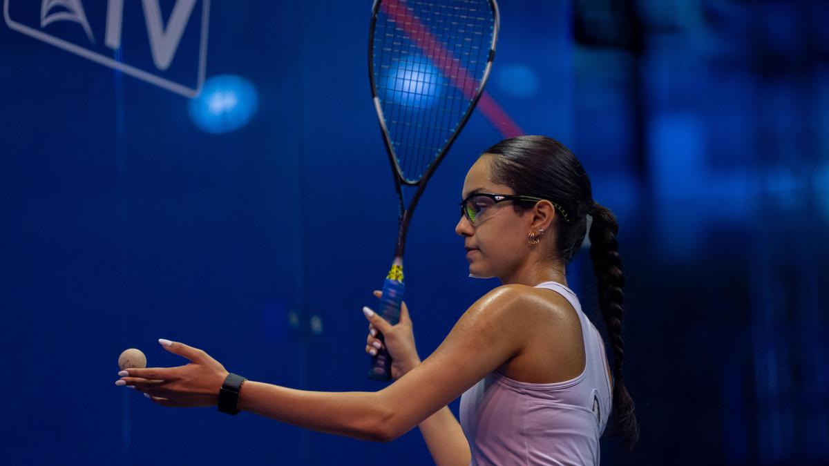 Young squash players competing intensely on indoor court at international junior championship tournament
