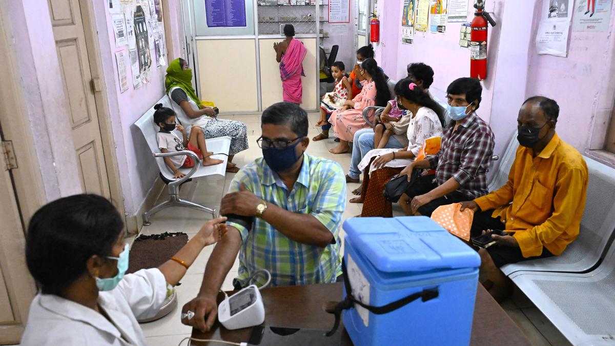 Doctor reviewing patient medical records on digital tablet in modern Indian hospital setting