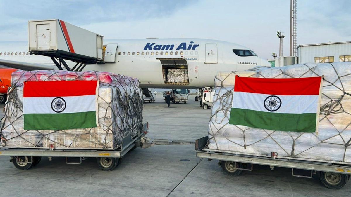 Relief supplies including tents and emergency kits being loaded for shipment to Afghanistan