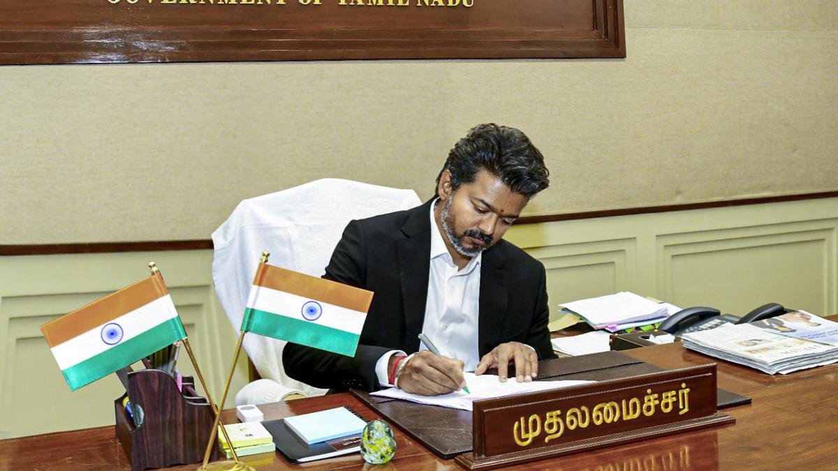 Tamil Nadu Chief Minister C. Joseph Vijay signing official documents at his swearing-in ceremony