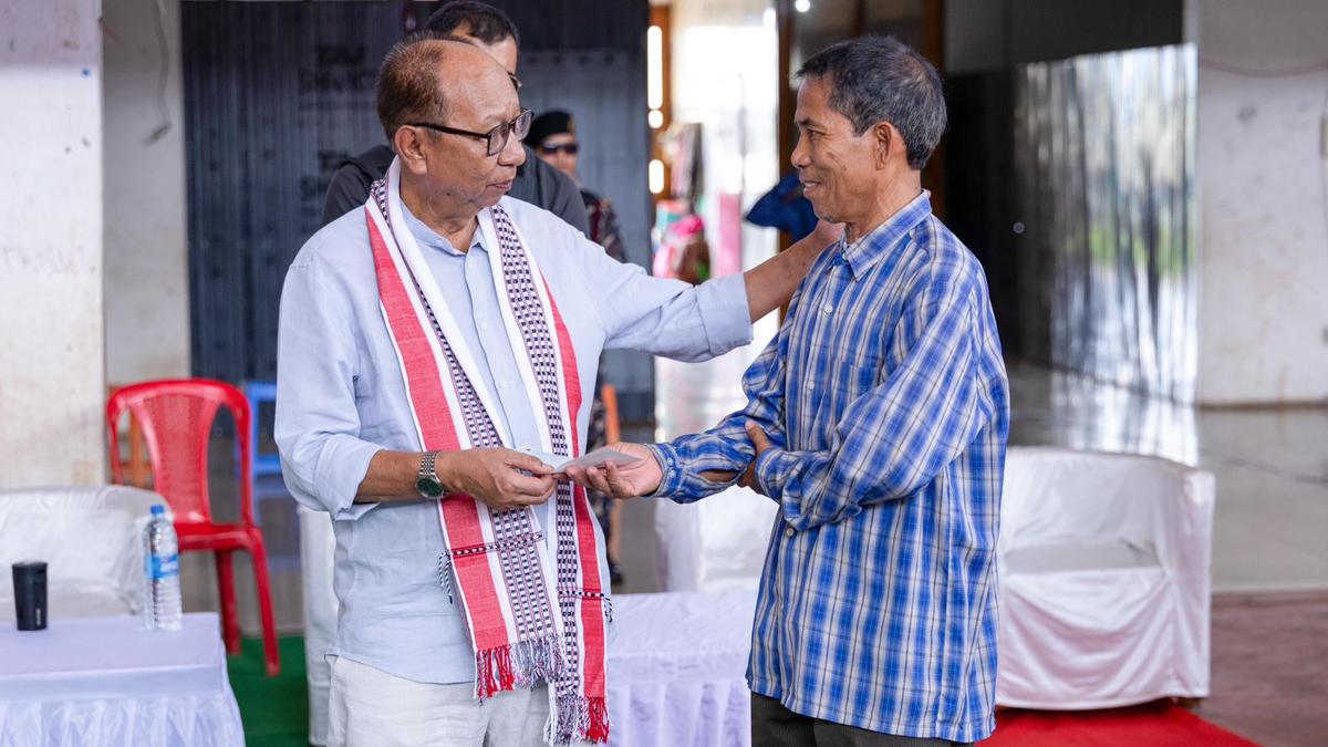 Chief Minister distributing financial assistance cheques to displaced families in Imphal relief camp
