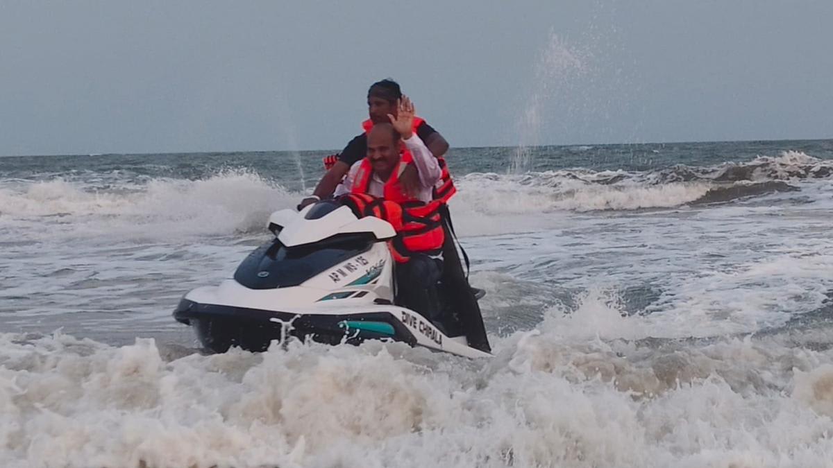 Tourists enjoying paramotor and jet ski activities at Ramapuram beach in Chirala, India