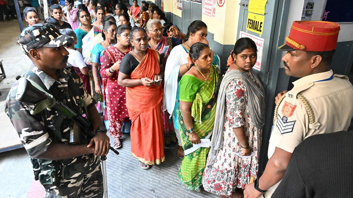 Voters standing in organized lines outside polling station in Puducherry, India during historic election