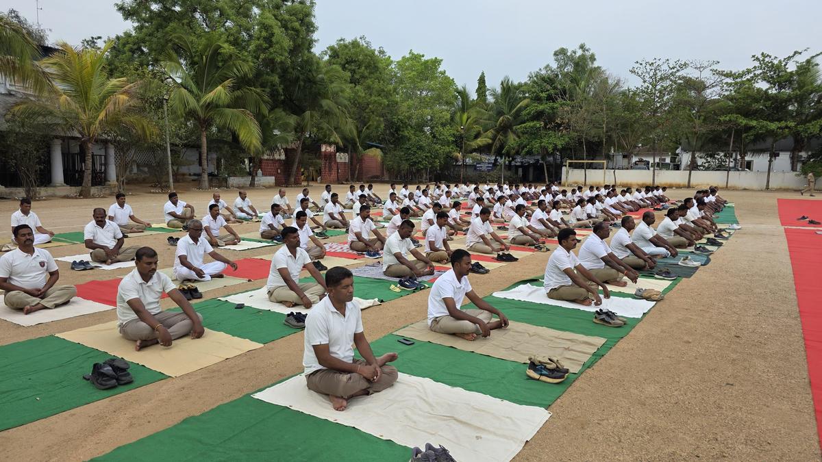 Police officers sitting in meditation poses during wellness training program in India