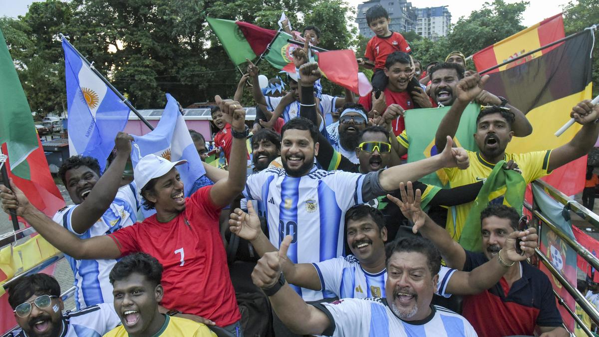 ** Indian football fans celebrating together while watching World Cup match on television screen