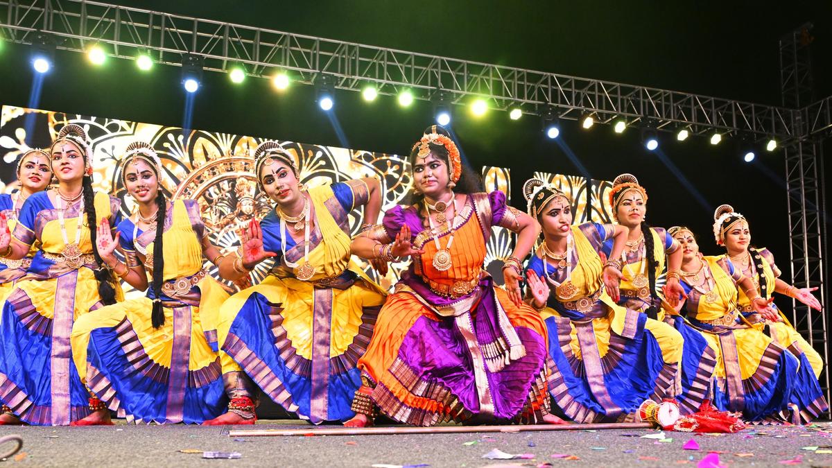 Students in colorful traditional costumes performing classical dance at Andhra University centenary celebration