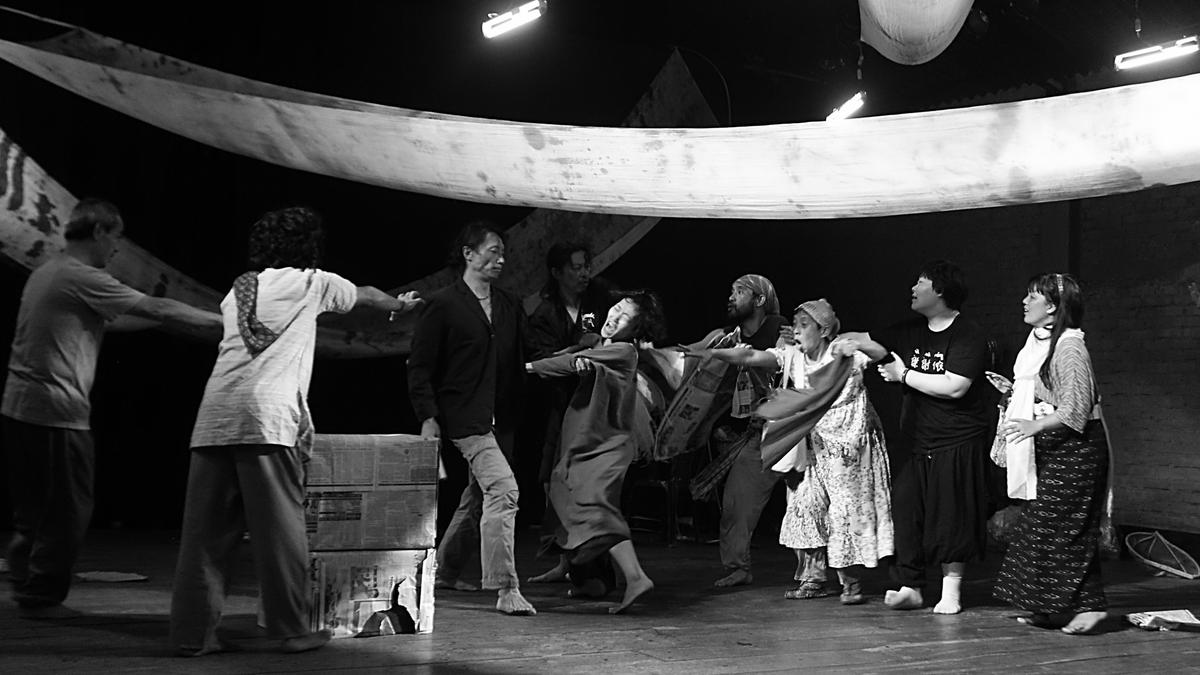 Black and white photograph of traditional Manipuri folk performer captured mid-performance by Nicky Chandam