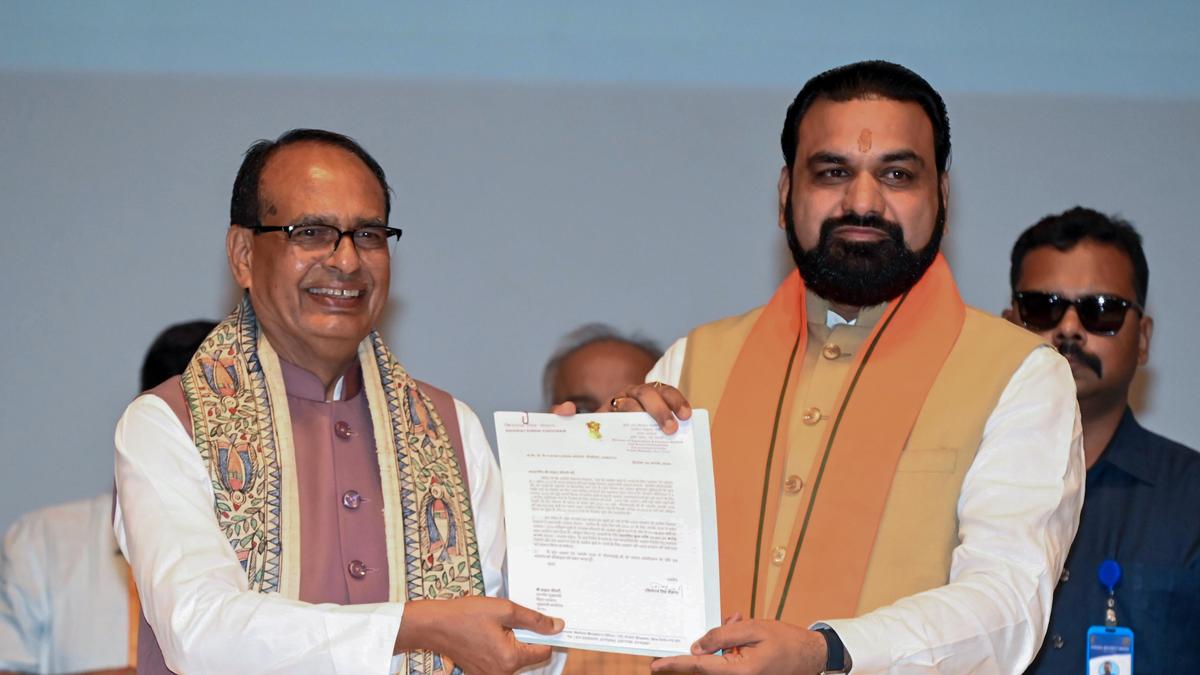 Government officials handing house keys to families during housing ceremony in Bihar, India