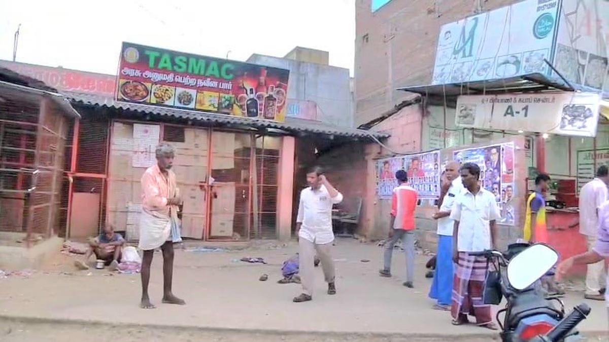 Bus terminal entrance in Vellore, Tamil Nadu with commuters boarding vehicles safely