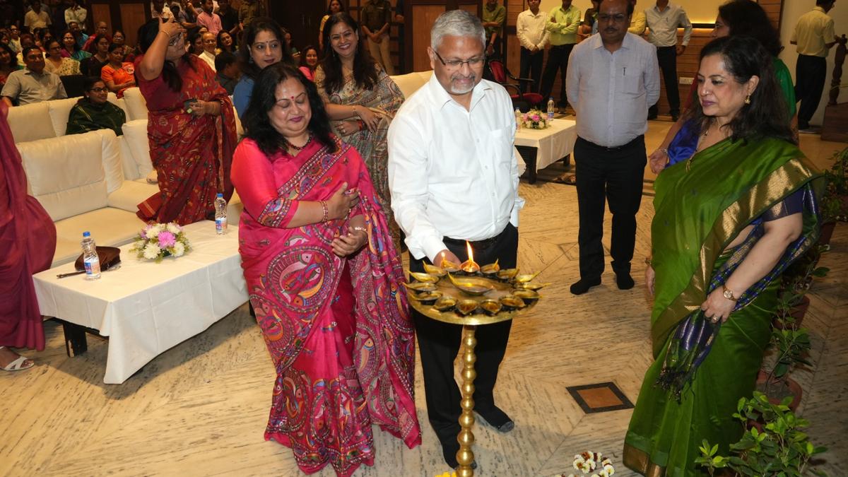 Women railway employees in uniform receiving awards and certificates at Eastern Railway ceremony