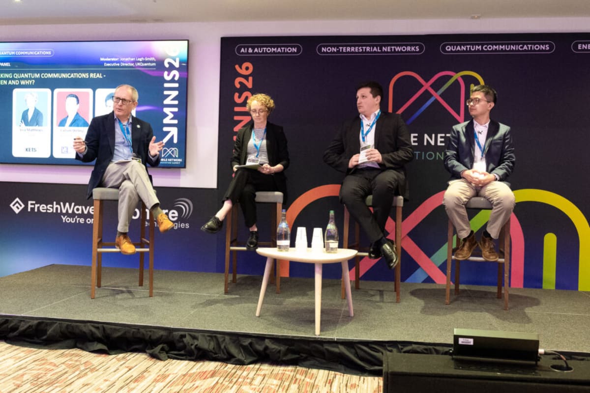 Scientists and business leaders discussing quantum technology innovation at London innovation summit conference