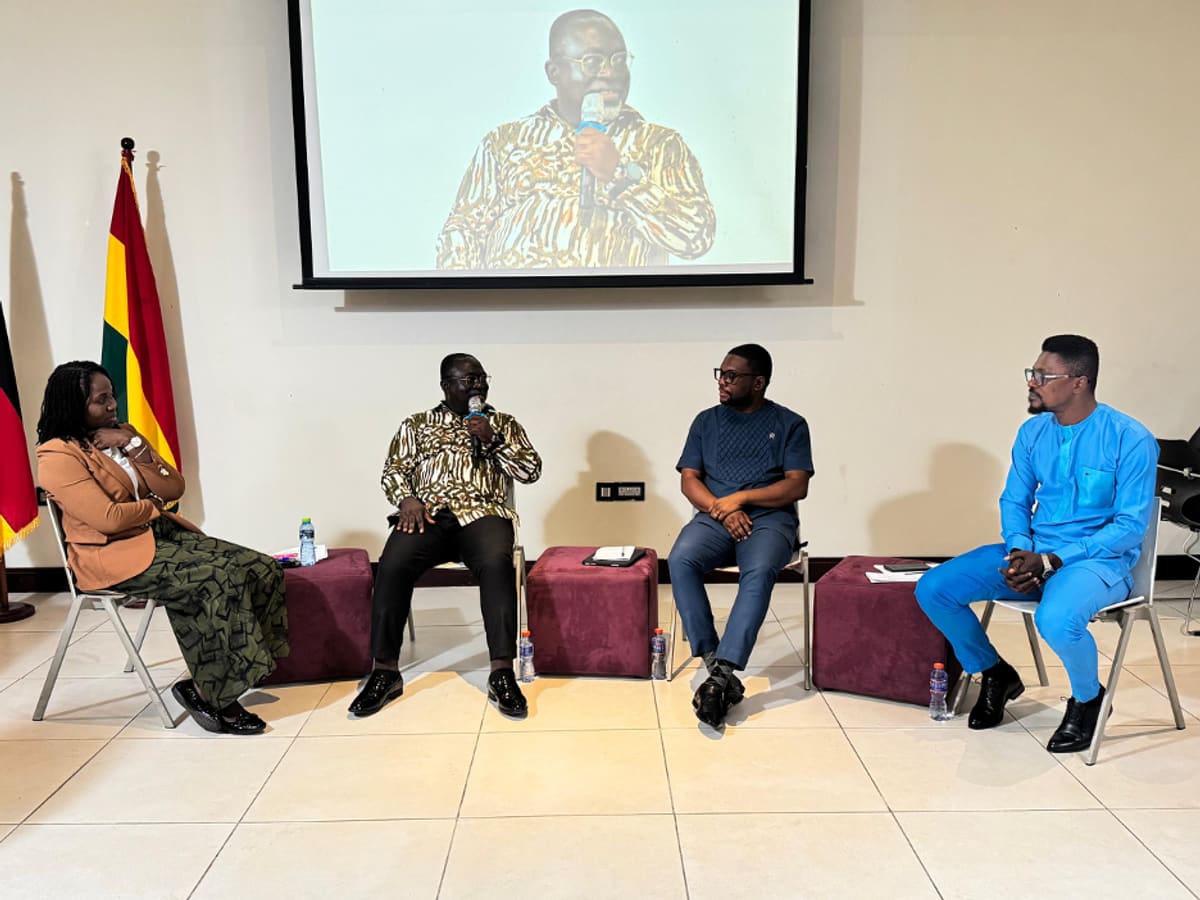 Young Ghanaian job seekers meeting with employers at career fair booth in Takoradi