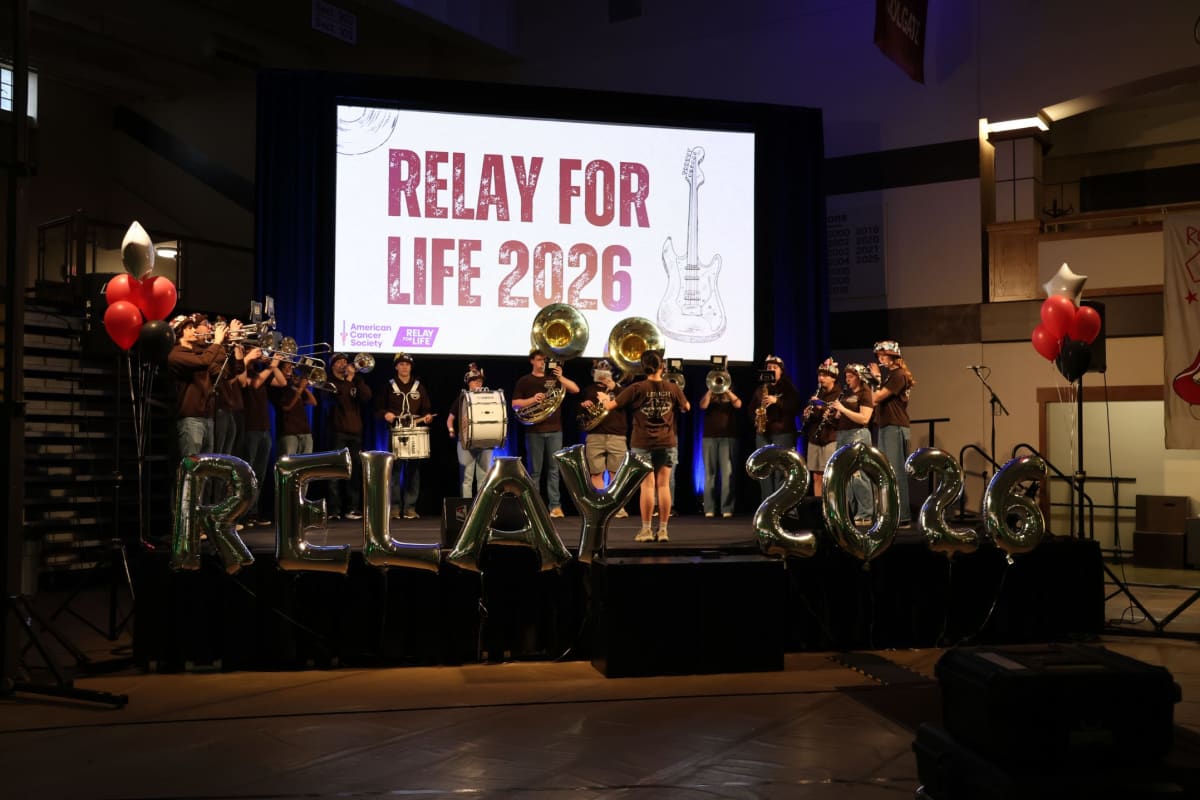College students gathering at decorated indoor venue for cancer fundraising relay event
