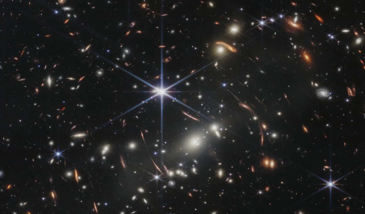 Webb Telescope Finds Hidden Galaxy Warped by Space Itself
