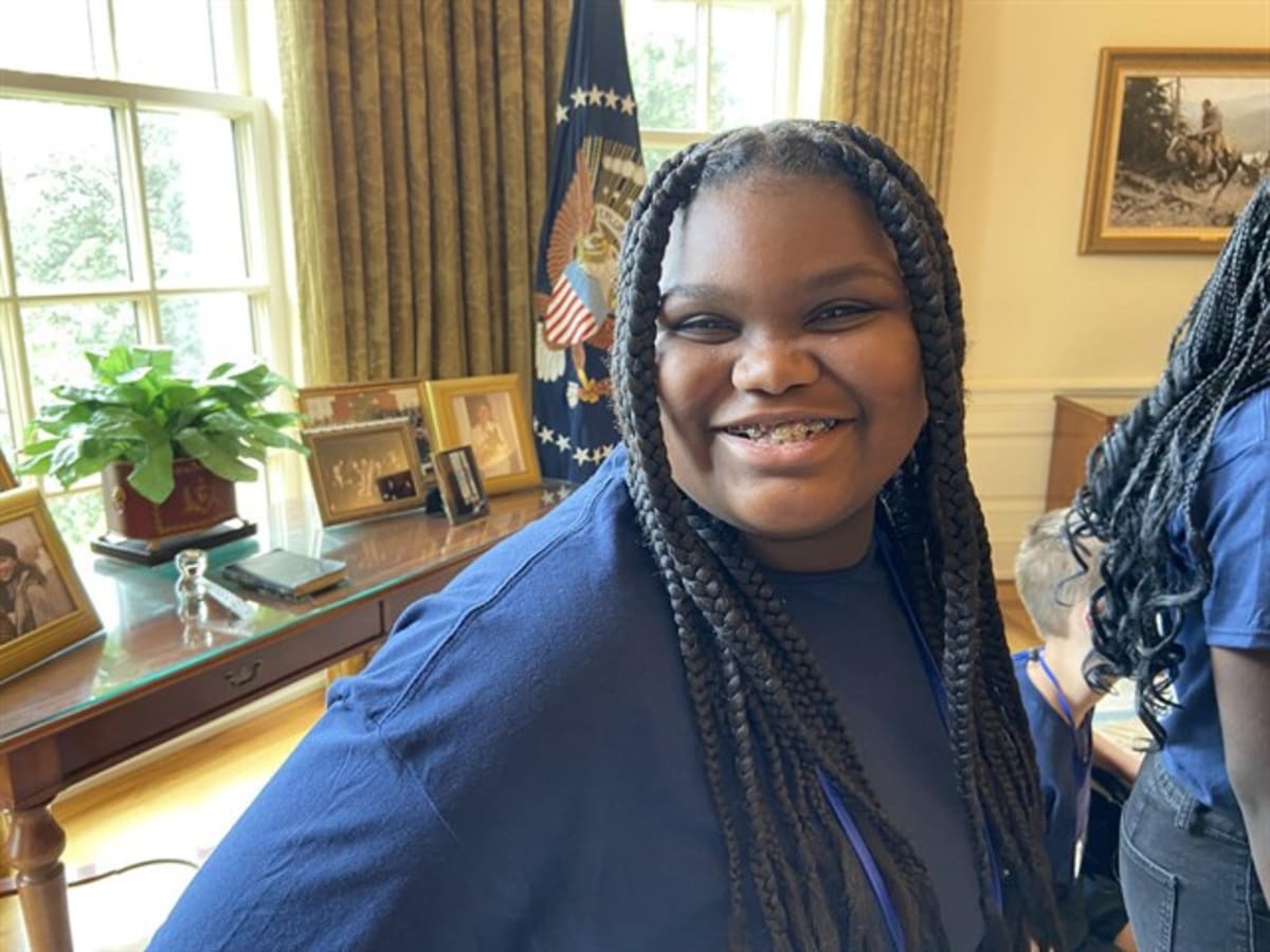 Middle school student standing confidently at Texas State Capitol building in Austin
