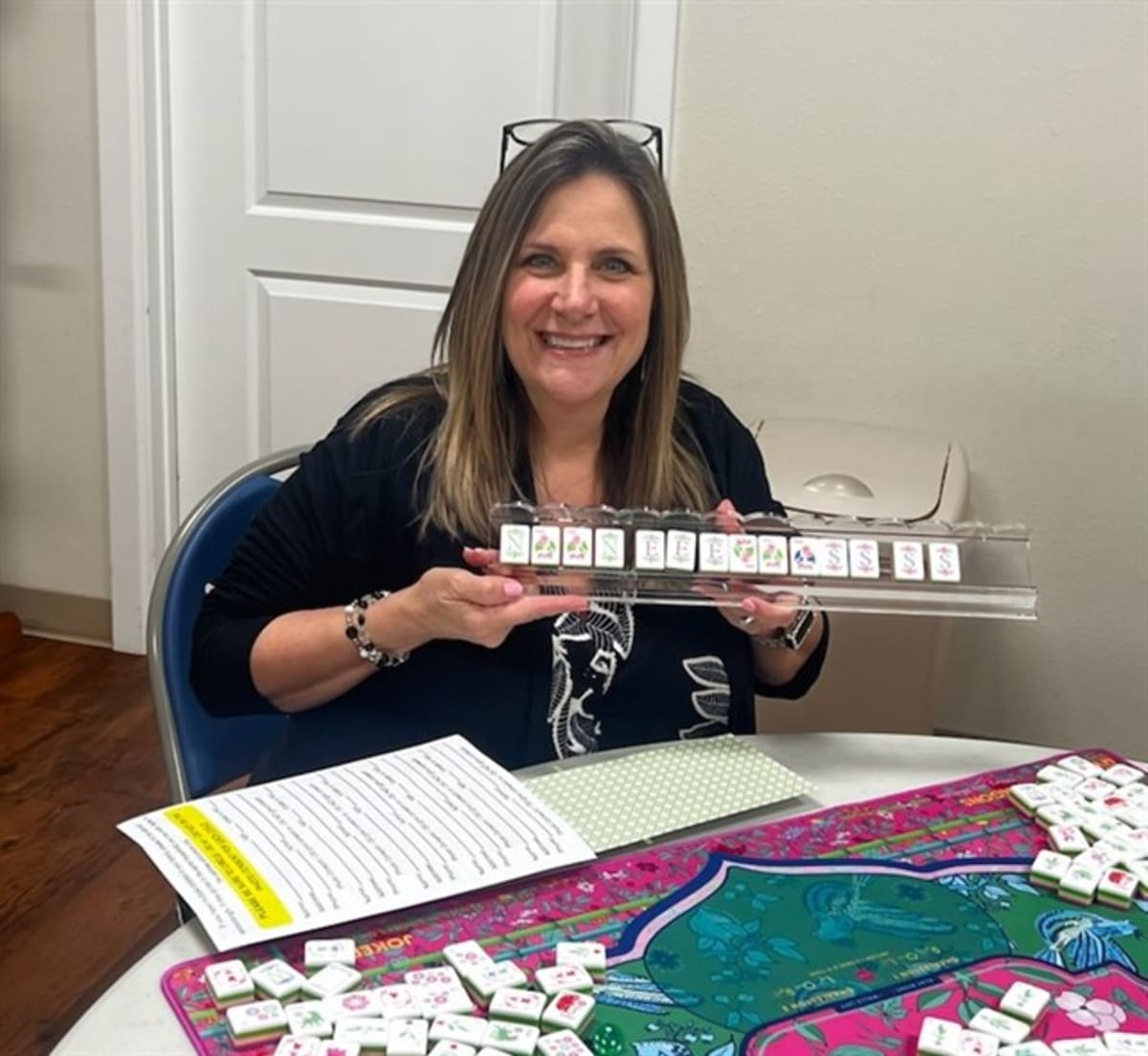 Community members playing Mahjong tiles together at Mt. Enterprise Library event in Texas
