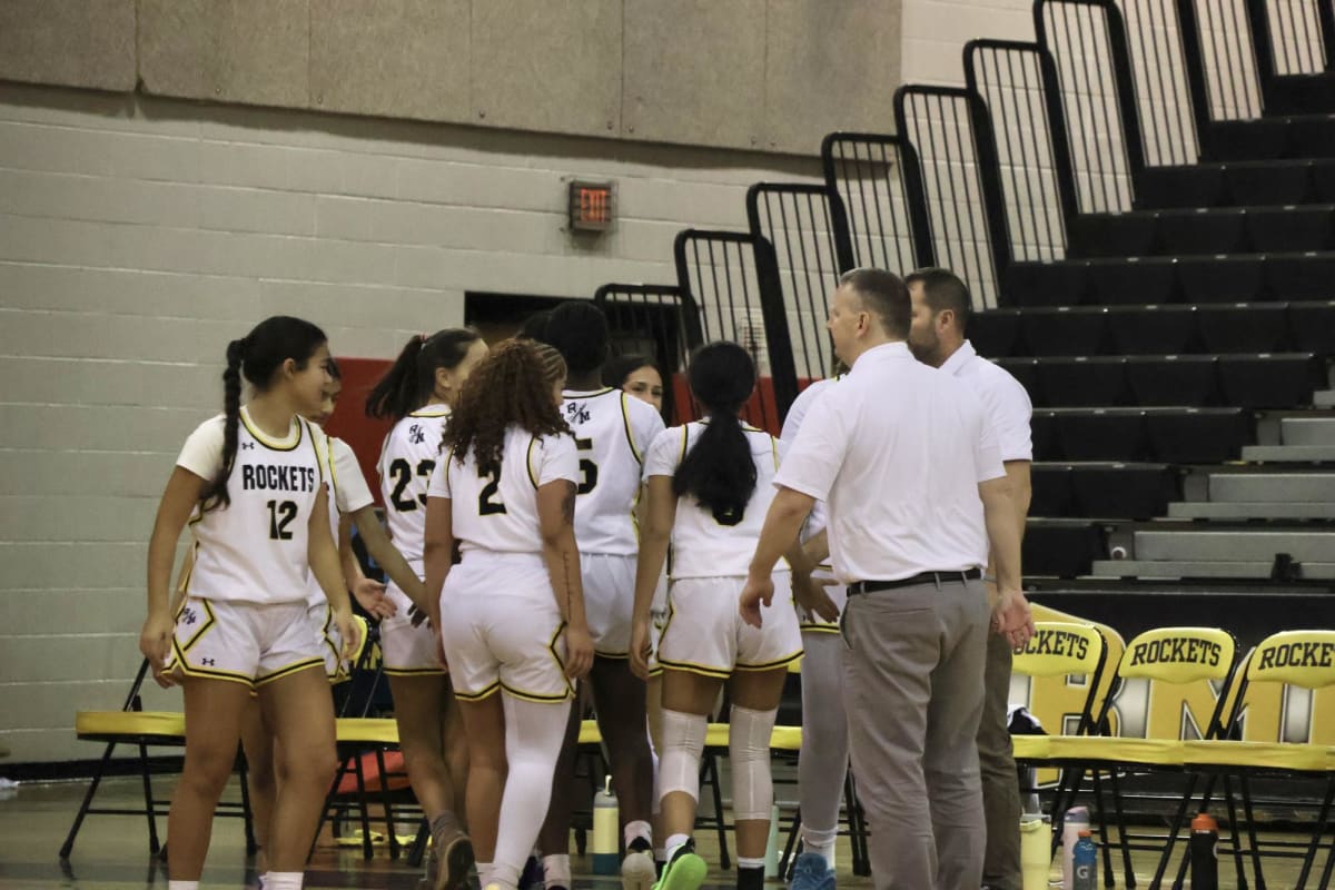 Richard Montgomery Rockets girls basketball team huddles together before championship tip-off