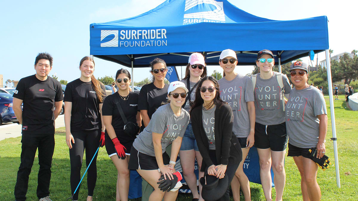 Volunteers collecting trash in bags during beach cleanup at Seal Beach, California