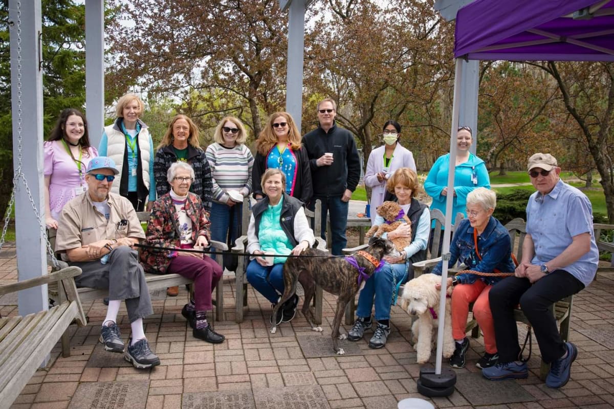 Arbor Hospice volunteers gather with therapy dogs at community event celebrating volunteer week
