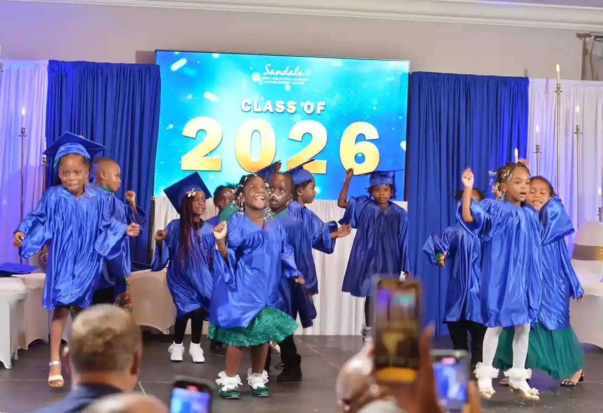 Young children in graduation caps and gowns at Sandals Early Childhood Learning Centre ceremony