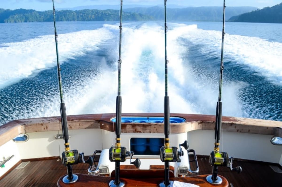 Sport fishing boat off Costa Rica's coast with captain and tourists aboard