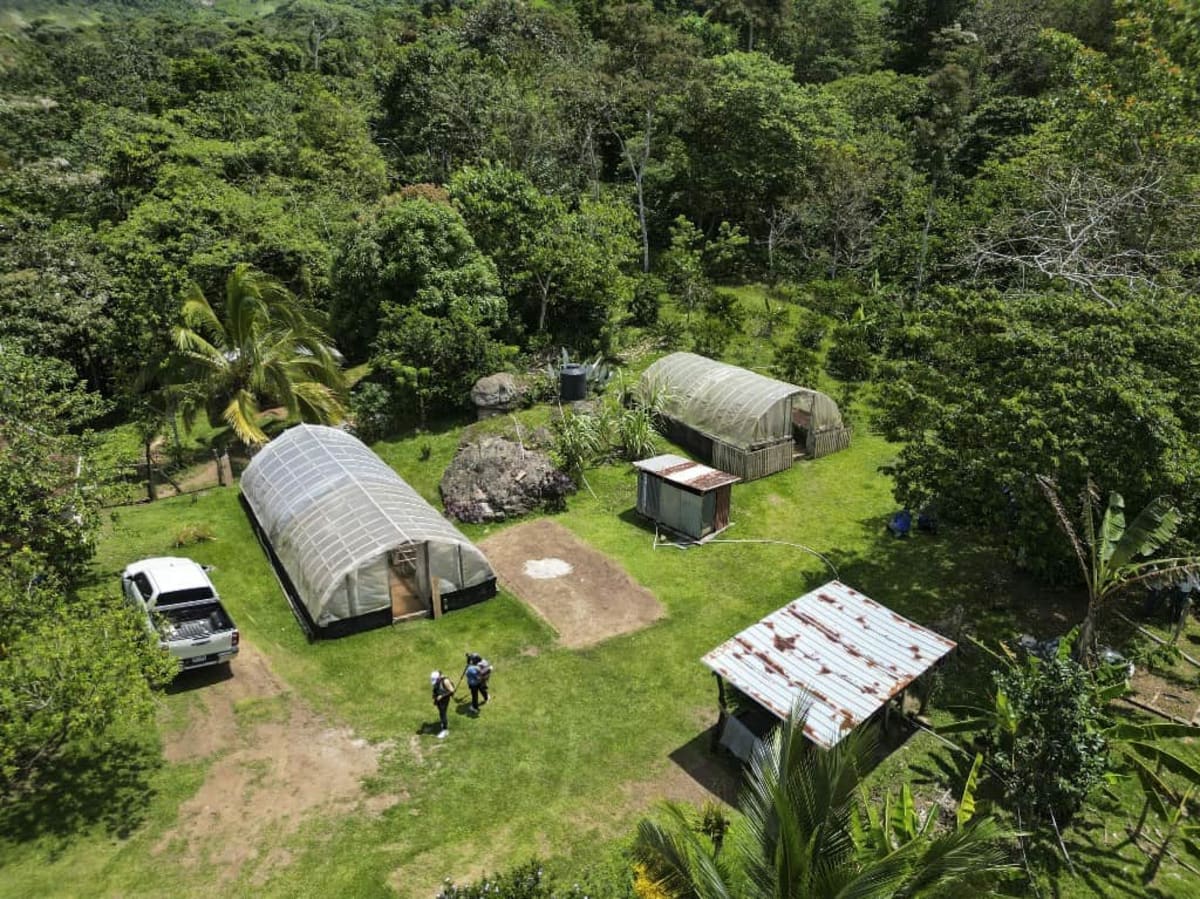 Satellite dish providing internet connectivity in rural Costa Rican mountain landscape with clear sky