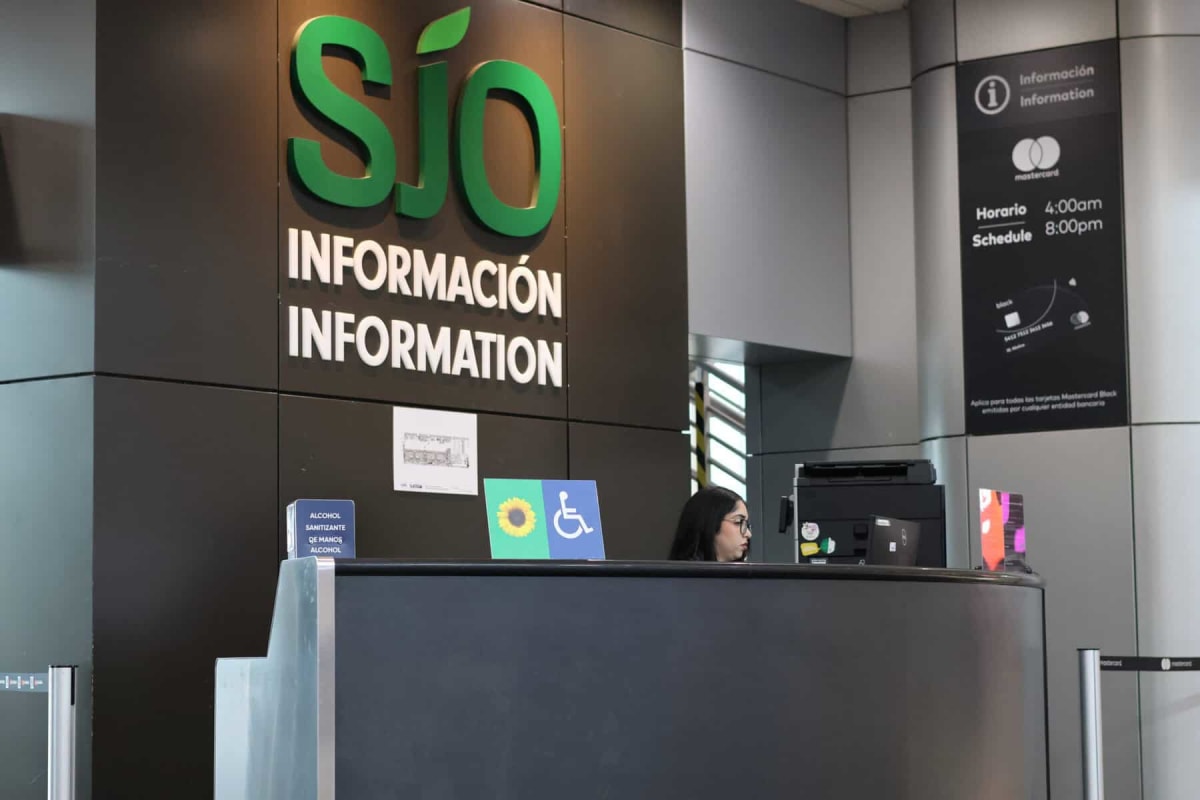 Sunflower lanyard symbol displayed at Juan Santamaría International Airport information desk in Costa Rica